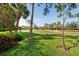 Home with beautiful landscaping overlooking a lush green golf course on a sunny day at 5336 Huntingwood Ct # 24, Sarasota, FL 34235