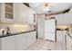 Traditional white kitchen featuring ample cabinet space and neutral countertops at 5336 Huntingwood Ct # 24, Sarasota, FL 34235