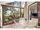 Enclosed lanai with glass table and chairs overlooking lush garden at 5336 Huntingwood Ct # 24, Sarasota, FL 34235