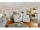 Living room featuring vaulted ceilings, hardwood floors, sliding glass doors to a covered patio, and neutral decor at 5336 Huntingwood Ct # 24, Sarasota, FL 34235