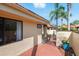 A paved walkway with brick pavers leads to a charming courtyard with lush landscaping and seating areas at 5336 Huntingwood Ct # 24, Sarasota, FL 34235