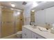 Well-lit bathroom features a vanity with sink, toilet and frosted-glass enclosed shower at 536 Lakeside Dr # 0, Bradenton, FL 34210