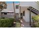 A bright condo exterior featuring a private patio, staircase, and verdant greenery at 536 Lakeside Dr # 0, Bradenton, FL 34210