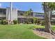 Well-maintained condo building with tropical landscaping and green lawn in a sunny setting at 536 Lakeside Dr # 0, Bradenton, FL 34210