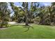 Lush front yard featuring a green lawn and mature trees offering plenty of shade at 536 Lakeside Dr # 536, Bradenton, FL 34210