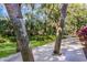 Scenic walkway lined with lush foliage, trees, and a well-maintained gravel path at 536 Lakeside Dr # 0, Bradenton, FL 34210