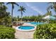 Community pool with hot tub, lounge chairs, lush landscaping, and blue skies offering a resort-like feel at 536 Lakeside Dr # 0, Bradenton, FL 34210