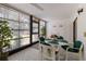 Enclosed sunroom with tiled floor, ceiling fan and dining table overlooking lush outdoor greenery at 536 Lakeside Dr # 0, Bradenton, FL 34210