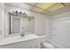 Bright bathroom features white fixtures, a large mirror, and vanity at 5800 Hollywood Blvd # 312, Sarasota, FL 34231