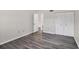 Bedroom with grey wood floors and large closet with louvered doors at 5800 Hollywood Blvd # 312, Sarasota, FL 34231