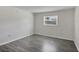 A modest bedroom featuring grey wood floors and a window at 5800 Hollywood Blvd # 312, Sarasota, FL 34231
