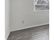 A simple, bright bedroom with grey wood floors and natural light at 5800 Hollywood Blvd # 312, Sarasota, FL 34231