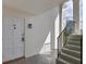 Exterior entryway with stairs, white door, and stylish light fixture illuminating the space at 5800 Hollywood Blvd # 312, Sarasota, FL 34231