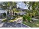 Exterior view of property showcasing mature tropical landscaping at 5800 Hollywood Blvd # 312, Sarasota, FL 34231