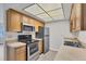 Well-lit kitchen featuring stainless steel appliances and wooden cabinetry at 5800 Hollywood Blvd # 312, Sarasota, FL 34231