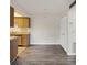 Open floor plan with wood floors, showcasing the kitchen and pantry at 5800 Hollywood Blvd # 312, Sarasota, FL 34231