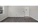 Open living space with gray flooring, bright white walls, and a white front door at 5800 Hollywood Blvd # 312, Sarasota, FL 34231