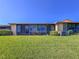 Back of the home showcases well-maintained lawn and a sunroom extension at 6218 29Th W Ave # 6218, Bradenton, FL 34209