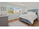 Well-lit bedroom featuring bright natural light, hardwood floors and cozy decor at 6218 29Th W Ave # 6218, Bradenton, FL 34209