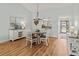 Dining area showcases a stylish chandelier, beach artwork, and comfortable seating at 6218 29Th W Ave # 6218, Bradenton, FL 34209