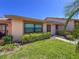 Well-maintained exterior with manicured lawn, shrubs, and a concrete pathway leading to the entrance at 6218 29Th W Ave # 6218, Bradenton, FL 34209