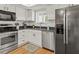 Updated kitchen features stainless steel appliances, white cabinetry, and a view of the backyard at 6218 29Th W Ave # 6218, Bradenton, FL 34209