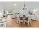 Open-concept living area with dining table, vaulted ceilings, hardwood floors, and ample natural light at 6218 29Th W Ave # 6218, Bradenton, FL 34209