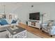 Cozy living room featuring a sofa, wood floors, and a TV console at 6218 29Th W Ave # 6218, Bradenton, FL 34209