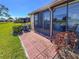 Patio area featuring brick pavers, an air conditioning unit, and access to the sunroom at 6218 29Th W Ave # 6218, Bradenton, FL 34209