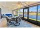 Enclosed patio with lake views, comfortable seating, and sliding doors to indoor living spaces at 6218 29Th W Ave # 6218, Bradenton, FL 34209