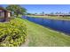 Peaceful water view from this home with bright blue skies and manicured lawn at 6218 29Th W Ave # 6218, Bradenton, FL 34209