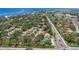 Expansive aerial shot showcasing a community with tree-lined streets and stunning coastal views at 6304 Pelican Dr, Bradenton, FL 34210