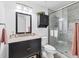 Bathroom featuring updated vanity, granite countertop, tiled shower with a glass door, and modern fixtures at 6304 Pelican Dr, Bradenton, FL 34210