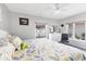 Bright bedroom with large windows, ceiling fan, gray walls, tiled floor, and white furniture at 6304 Pelican Dr, Bradenton, FL 34210
