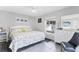 Bright bedroom with large window, ceiling fan, gray walls, tiled floor, and white furniture at 6304 Pelican Dr, Bradenton, FL 34210