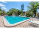 Spacious community pool area with ample lounge chairs, umbrellas, and well-maintained landscaping at 6304 Pelican Dr, Bradenton, FL 34210
