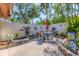 Serene private courtyard with brick-paved patio, seating, and lush tropical landscaping at 6304 Pelican Dr, Bradenton, FL 34210
