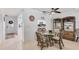 Bright dining area featuring a glass table, rattan chairs, and stylish nautical decor with a view into the kitchen at 6304 Pelican Dr, Bradenton, FL 34210