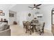 Bright dining area featuring a glass table and rattan chairs, located between the kitchen and the living room at 6304 Pelican Dr, Bradenton, FL 34210