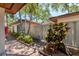Property exterior view with manicured landscaping, secure fencing, and a charming walkway leading to the entrance at 6304 Pelican Dr, Bradenton, FL 34210