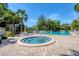 Inviting hot tub and pool area surrounded by comfortable seating and lush tropical landscaping at 6304 Pelican Dr, Bradenton, FL 34210