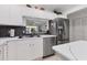 Well-lit kitchen with stainless steel appliances, white cabinetry, and a spacious layout for seamless cooking and dining at 6304 Pelican Dr, Bradenton, FL 34210