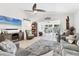 Comfortable living room with ample seating, tile floors, and a ceiling fan with sliding doors to the outside at 6304 Pelican Dr, Bradenton, FL 34210