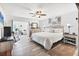 Bright main bedroom with a ceiling fan, beach-themed artwork, and an en-suite office space with natural light at 6304 Pelican Dr, Bradenton, FL 34210