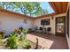Charming courtyard with beautiful landscaping, seating, and inviting entry perfect for relaxation and entertaining at 6304 Pelican Dr, Bradenton, FL 34210
