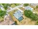 Aerial shot of a home with a screened pool and backyard, mature landscaping, and neighborhood street at 6405 99Th E St, Bradenton, FL 34202