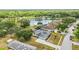 Aerial view of a home featuring a pond with water feature, mature landscaping, and a large driveway at 6405 99Th E St, Bradenton, FL 34202
