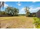 Large backyard with beautiful trees and partial view of a neighborhood pond at 6405 99Th E St, Bradenton, FL 34202