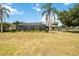 Spacious backyard featuring well-maintained grass, trees, and a screened enclosure at 6405 99Th E St, Bradenton, FL 34202