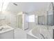 Floral bathroom with a large soaking tub, a shower, and dual sinks at 6405 99Th E St, Bradenton, FL 34202